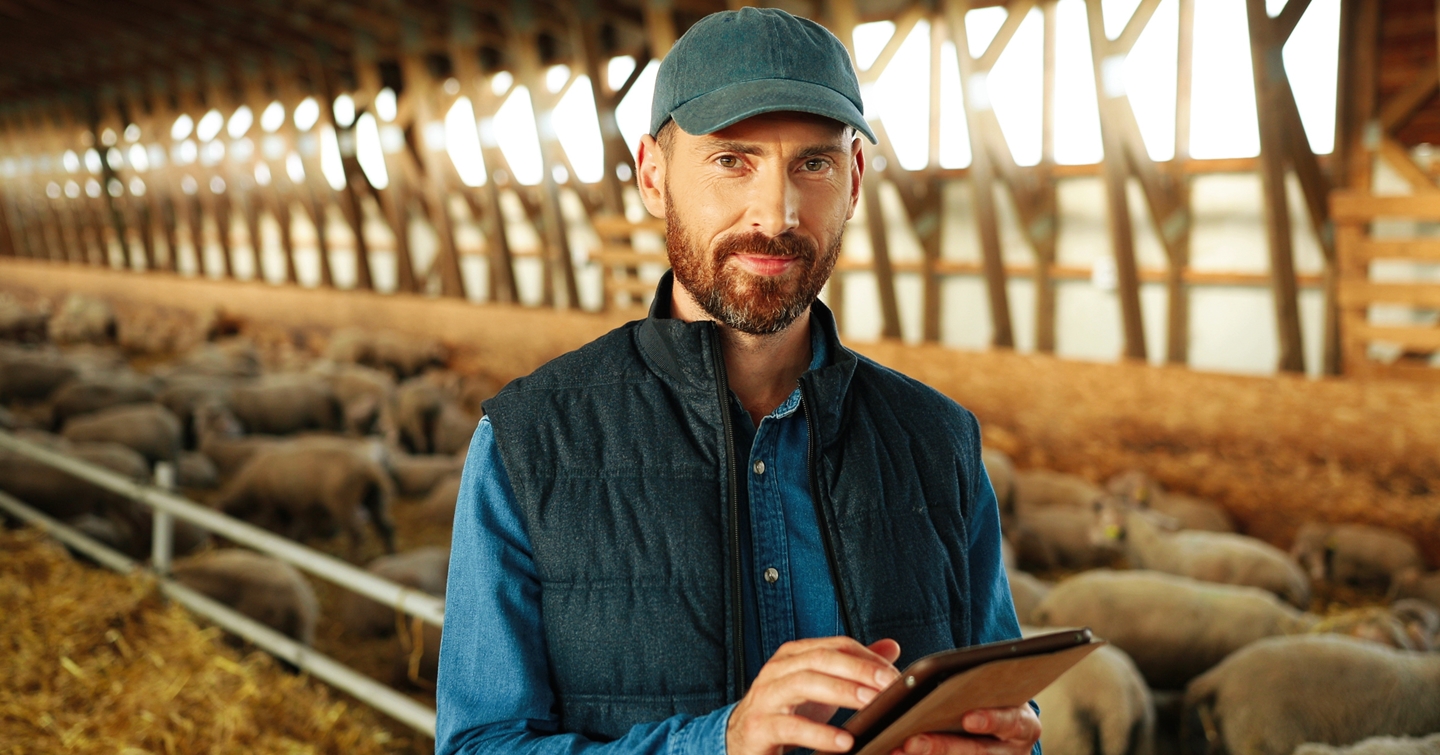Header image of farmer with iPad for AQM Plus